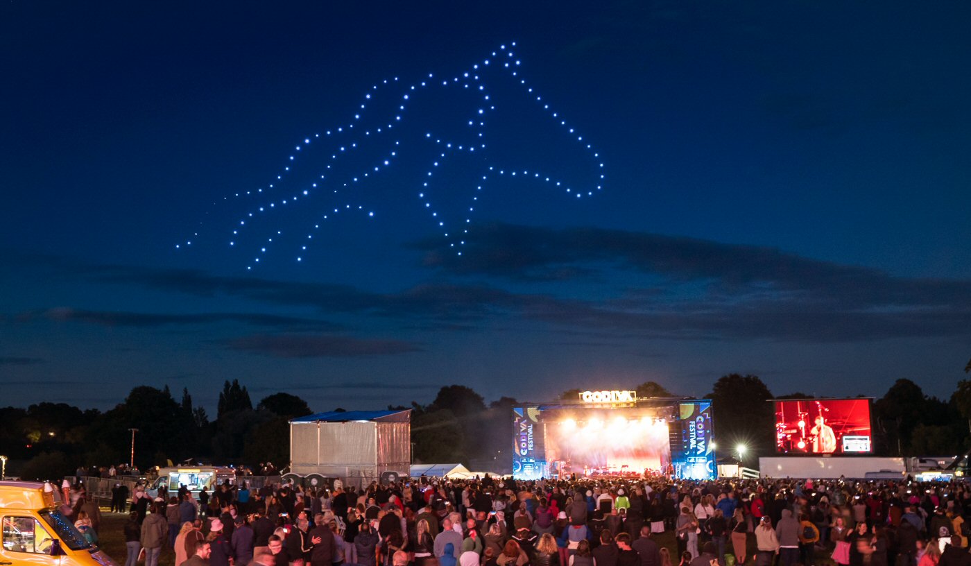 Godiva Festival audience watching a horse formed by drones above the main stage