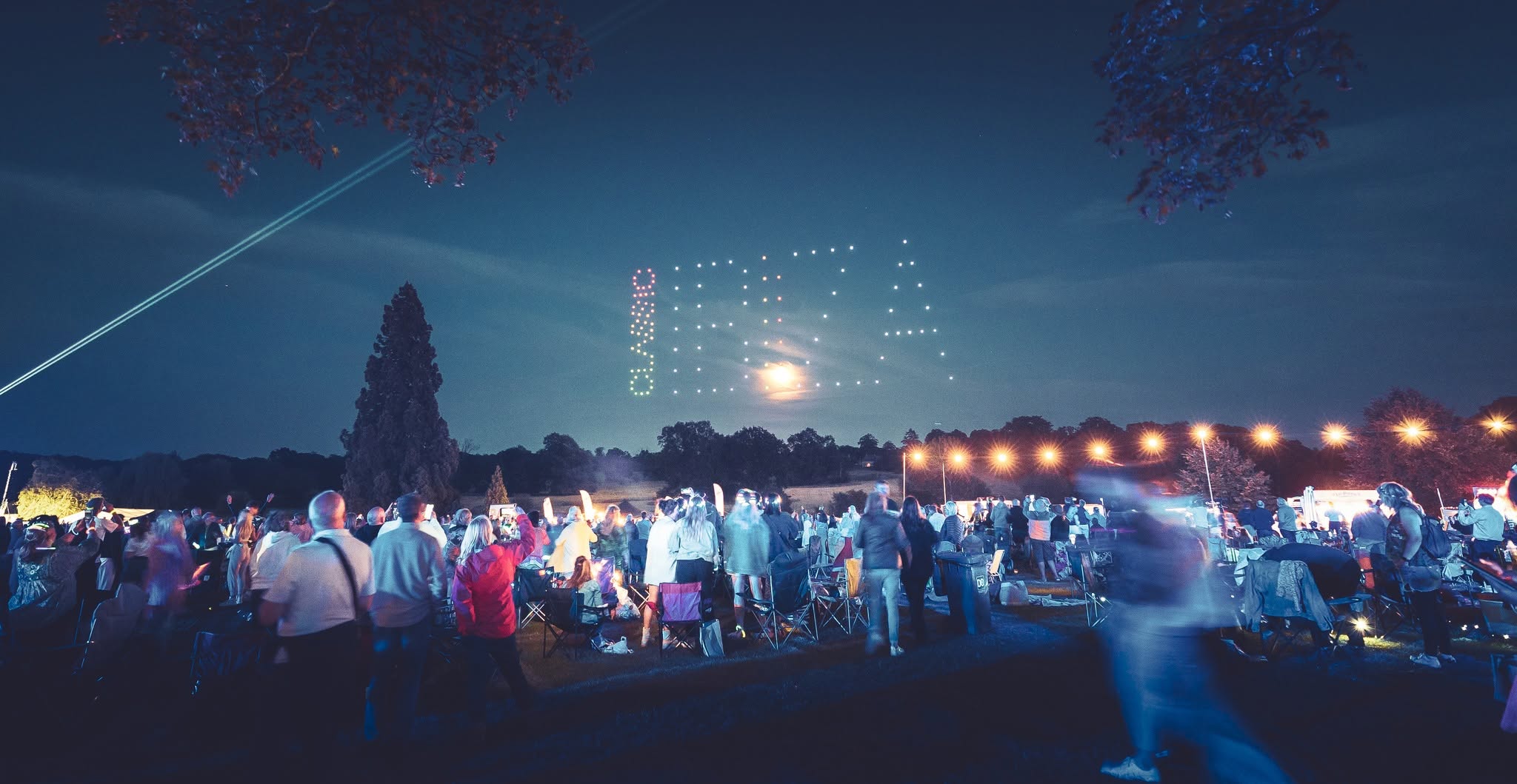 Classic Ibiza audience watching a drone formation above the festival site