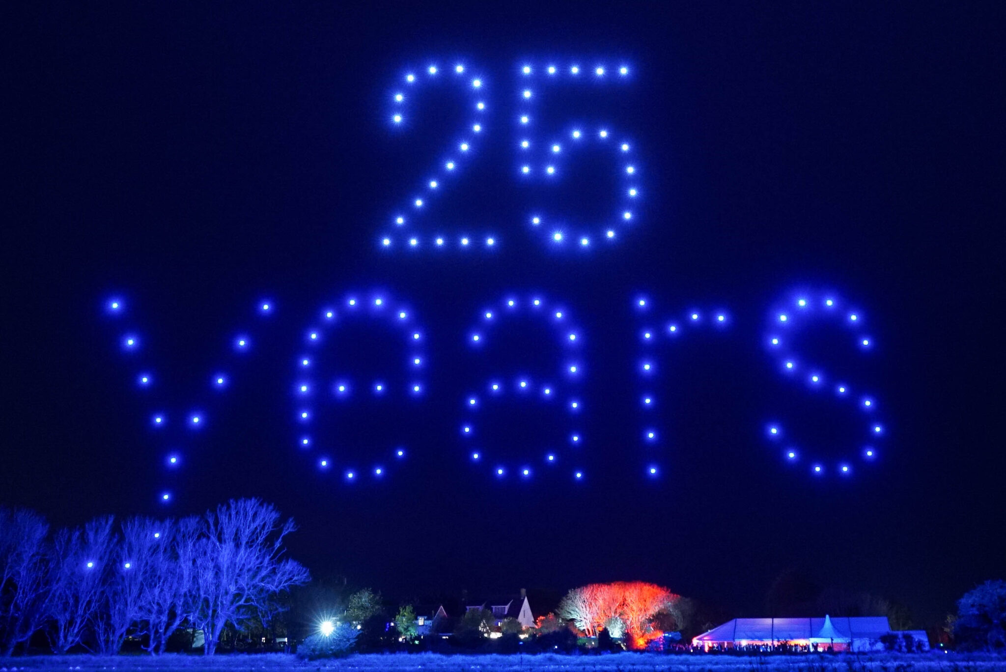 25 years message formed by drones above an event