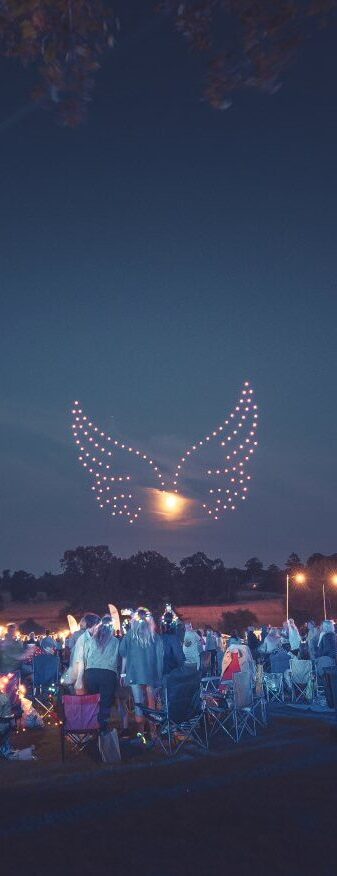The night event dazzled the crowd as a drone light show illuminated the sky, forming radiant wings around the moon.